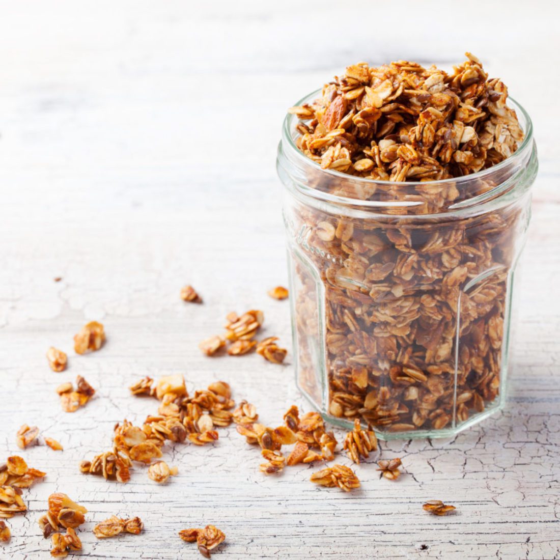 Healthy breakfast. Fresh granola, muesli in a glass jar. copy space.Organic oat,almond and sunflower seeds