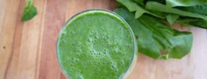 A green detox smoothie from above with some leaves