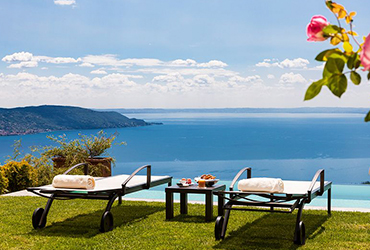 Sun loungers overlooking the ocean at Lefay resort