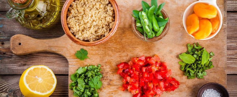 Ingredients to make tabbouli laid out on a wooden platter