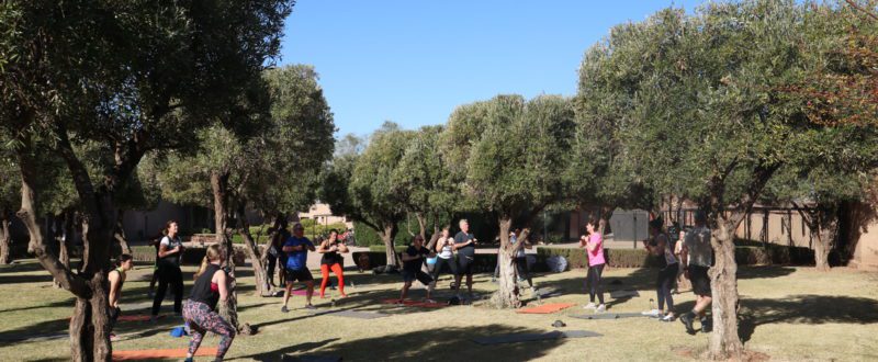 Group participating in a kettlebell work out in the sunshine in morocco